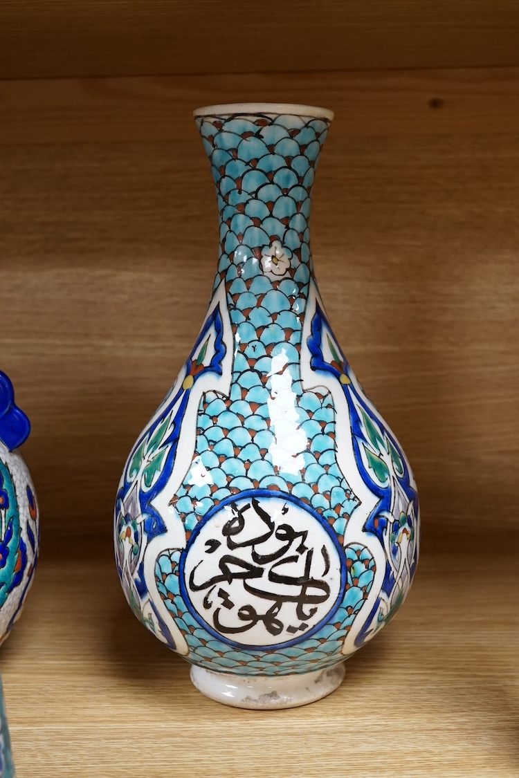 Two Persian vases and a mug, decorated with stylised flowers together with a Laroche Belgium Persian style vase, tallest 28.5cm. Condition - fair to good